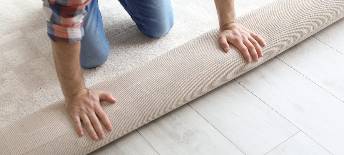 Man rolling out carpet