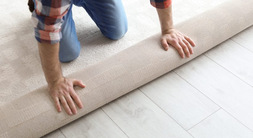 Man rolling out carpet
